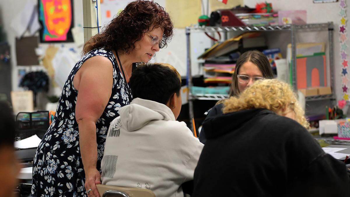 Teacher Francine Hicks helps her eighth-grade students with an assignment in her English and history class at Park Middle School in Kennewick.