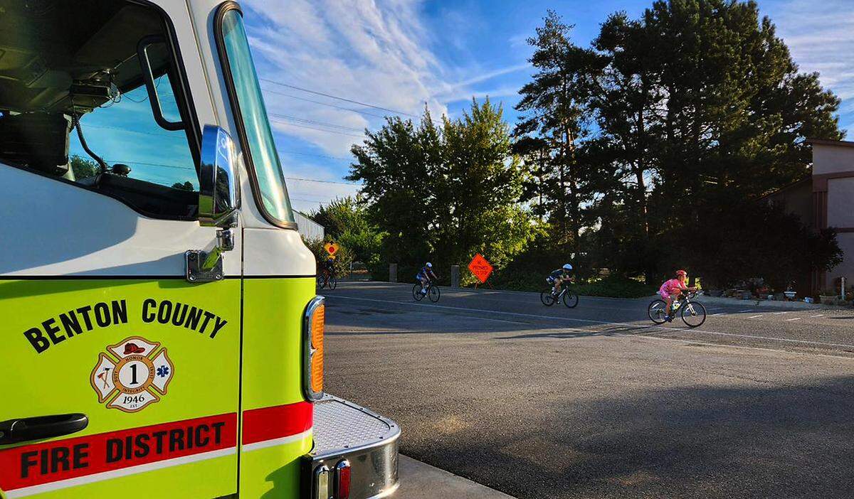 Participants in Ironman 70.3 Tri-Cities pedal past Benton County Fire District 1 Station 140 at 7704 S. Bermuda Rd. during their 56-mile cycling portion of the triathlon event.
