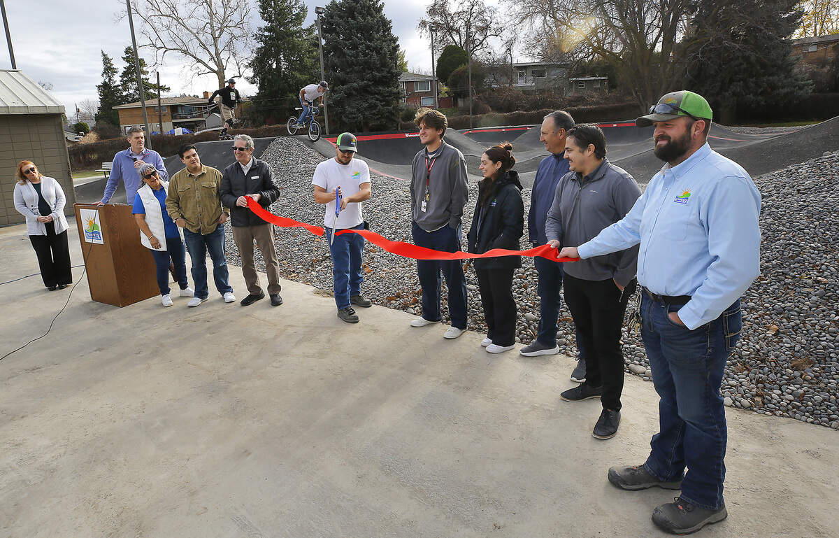 Daniel Helsley, Kennewick parks crew leader, cuts the ribbon during Thursday's opening ceremony  of the new Vancouver Park pump track in Kennewick. The new park amenity offers a roller-coaster-like ride to bicyclists and skateboarders.
