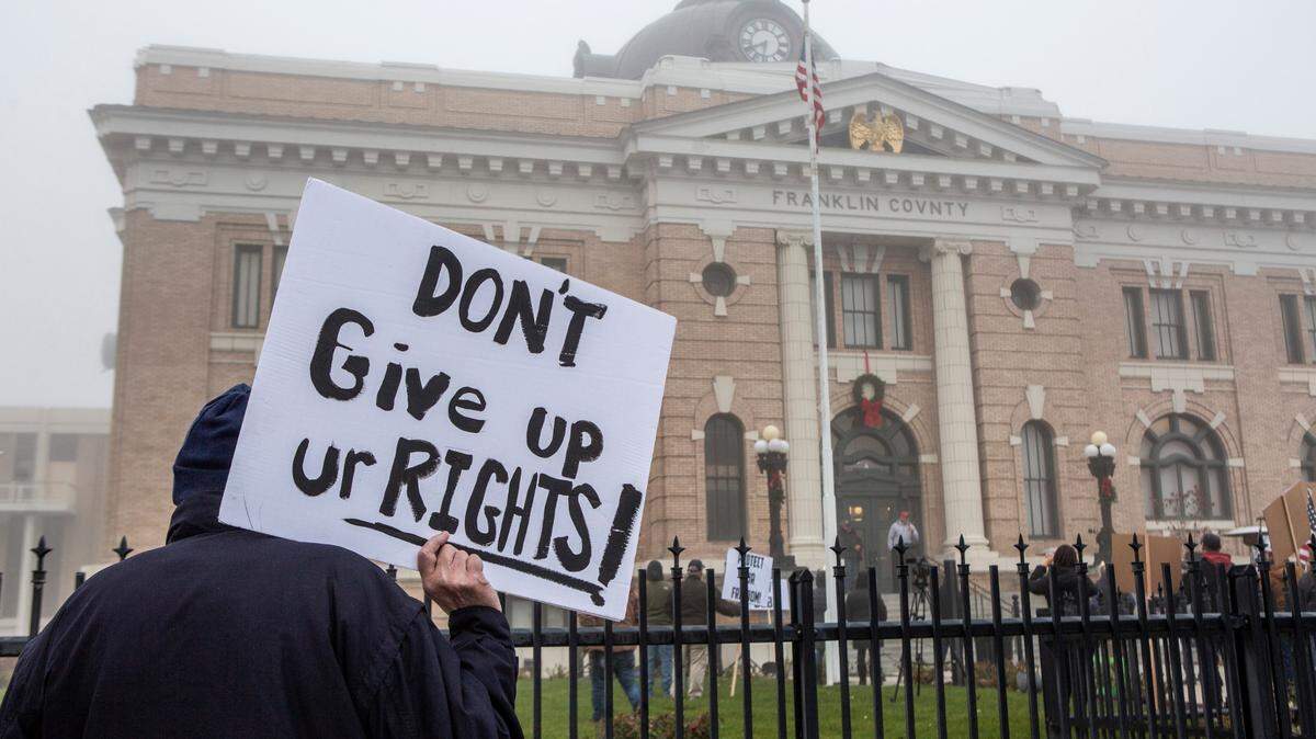 Supporters for ending the Washington state coronavirus restrictions gather outside of the Franklin County Courthouse in Pasco in 2020.