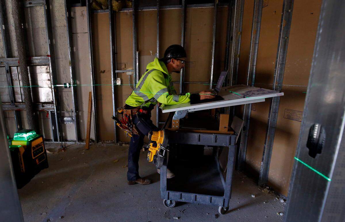 A green laser line is projected on the wall of a room as construction crews work to gut the first floor of the former hospital for the new Columbia Valley Center for Recovery facility.
