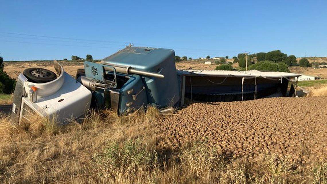 Spuds spilled along a Washington road after a semi rolled over on July 28, 2022, near Othello, Washington. The road was briefly closed while the truck was removed.