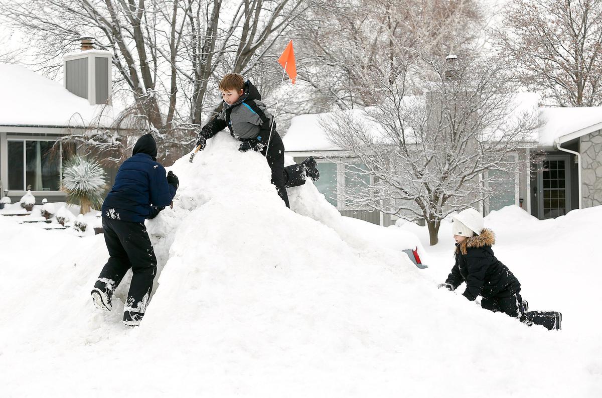 Neighborhood friends Porter Gibb, 9, left, and Marek Blakely, 9, and his sister, Jaelyn, 8, pretend to be mountaineers Wednesday while playing on a mound of snow created by a City of Kennewick front-end loader used to clear snow from their cul-de-sac in 8400 block of West Grand Ronde Place. Many students around the Mid-Columbia had another snow day because school districts canceled classes after another winter storm created hazardous driving conditions.