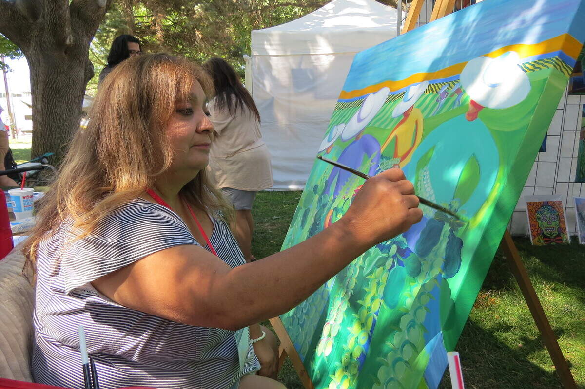 Consuelo Soto Murphy paints during Richland’s Art in the Park. It was one of two events that returned this weekend.