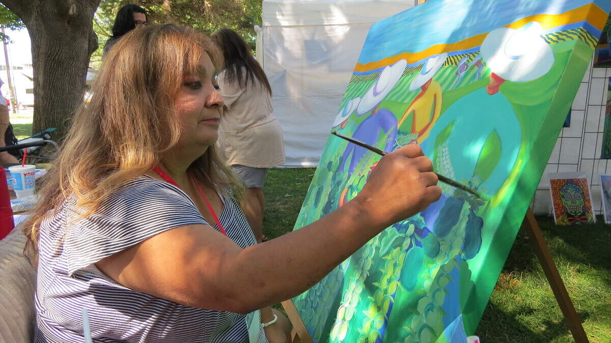 Consuelo Soto Murphy paints during Richland’s Art in the Park. It was one of two events that returned this weekend.