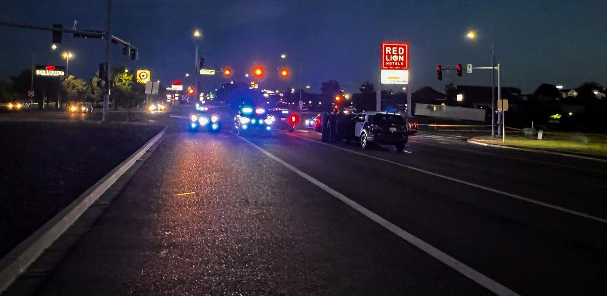 Law enforcement vehicles block the southbound lanes of Columbia Center Boulevard and Quinault Avenue Sunday night after a suspect in a stolen car crashed near the Kennewick intersection.