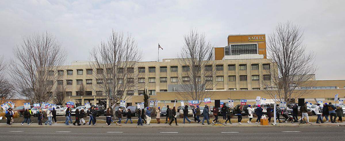 Dozens of nurses who belong to the Washington State Nurses Association hold an informational picket outside Kadlec Regional Medical Center in Richland. 