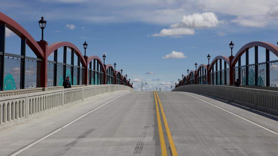 Pedestrians walk on the Lewis Street Overpass on Friday afternoon before a large car parade.