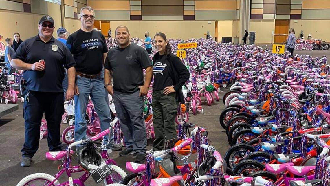 Pasco Officer Saul Mendoza, second from right, helped recruit other law enforcement officers from Pasco, Richland and West Richland and the Franklin County Sheriff’s Office to help with Bikes for Tikes assembly at the Three Rivers Convention Center.