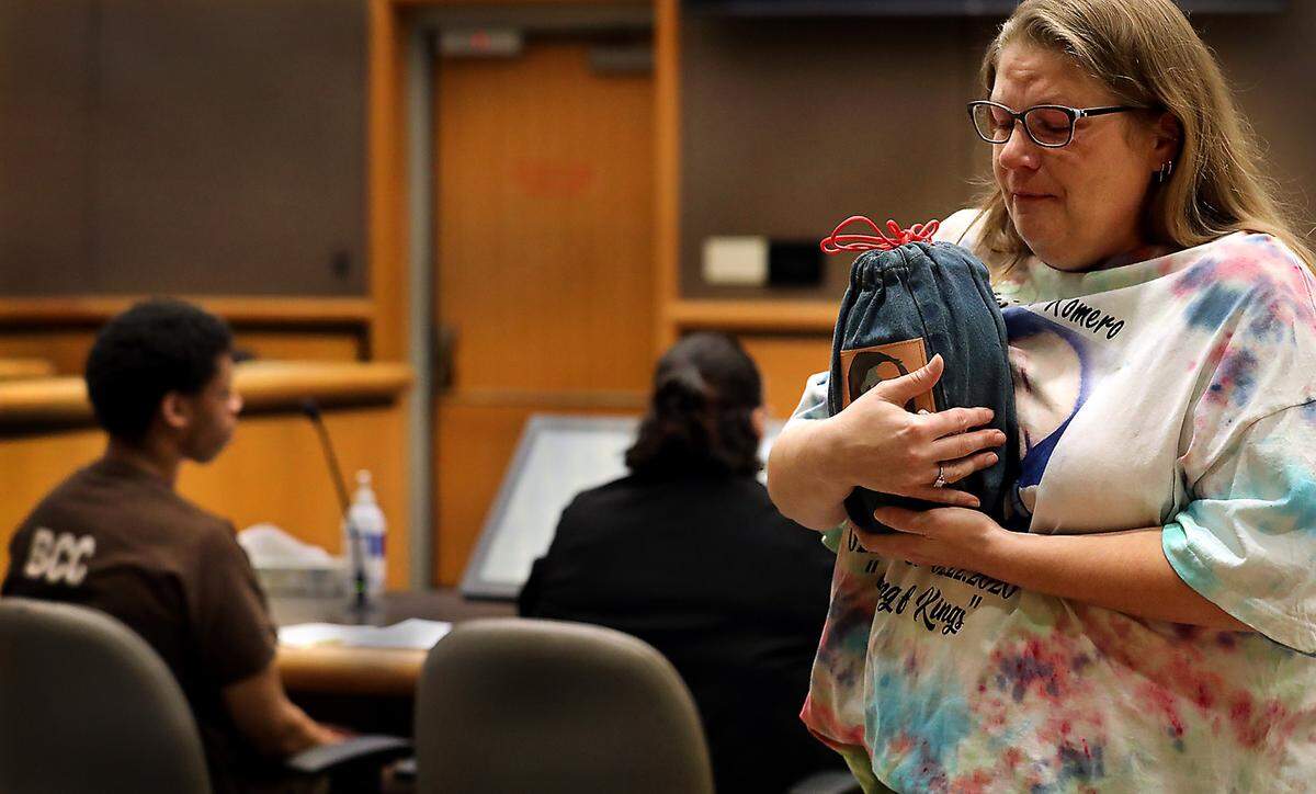 A tearful JaNaé Blakley, stepmother of murder victim Patrick Romero, cradles an urn with his remains after providing a family impact statement at the sentencing of Stuart B. Walker Monday in Benton County Superior Court in Kennewick. Judge Norma Rodriguez sentenced Walker to 10 years in prison for the February, 2020 fatal shooting of Patrick S. Romero, 21, in a West Bruneau Place parking lot, near Highway 395 in Kennewick.