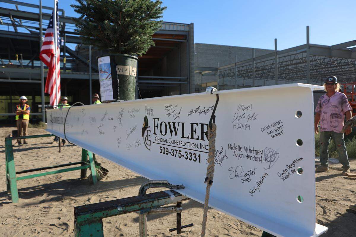 Dozens of signatures from Pasco School District staff, students, construction workers and community members cover the final structure beam for Sageview High School.