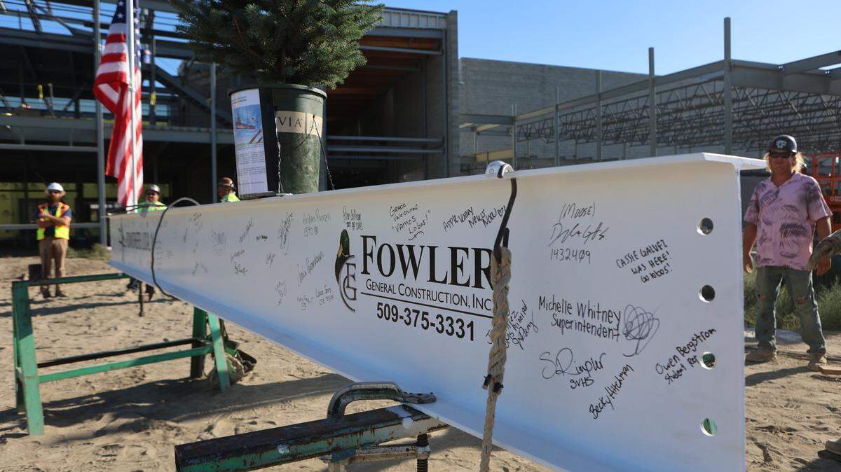 Dozens of signatures from Pasco School District staff, students, construction workers and community members cover the final structure beam for Sageview High School.