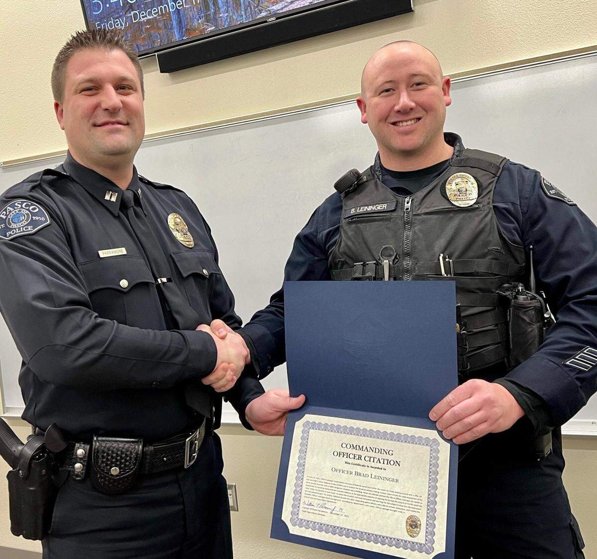 Capt. Bill Parramore presented Officer Richard “Brad” Leininger with a citation for a June 20 incident where he had an Ak-47 pointed at him.