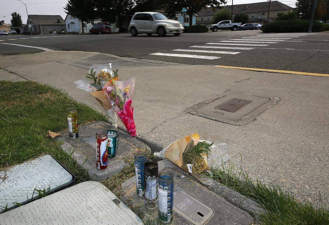 A memorial of candles and flowers have been placed for pedestrian Lorenzo Ayohua-Ramos who was hit by a car at West Clark Street near the crosswalk at North Sixth Avenue in Pasco. 