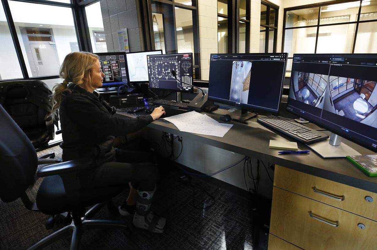 Detention officer Kelley Kelley watches video monitors showing security camera views in the master control room at the Benton County Juvenile Justice Center.