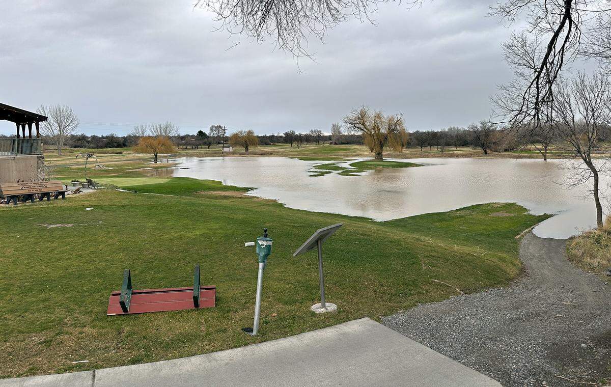 Water from the rising Yakima River begins to cover low parts of the West Richland Golf Course Thursday morning near the clubhouse. The front nine holes and the clubhouse at 4000 Fallon Drive remained open despite the new temporary water hazard.