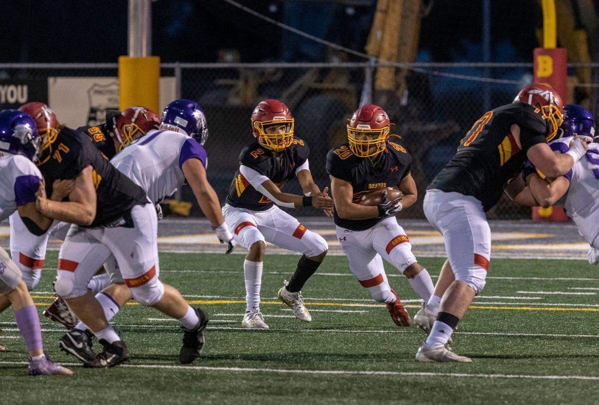 Kamiakin senior Henry Mercado hands off to Luis Salgado during the first round 4A state tournament game at Lampson Stadium in Kennewick.