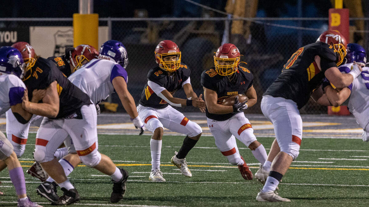 Kamiakin senior Henry Mercado hands off to Luis Salgado during the first round 4A state tournament game at Lampson Stadium in Kennewick. The Braves beat North Creek 56-21.