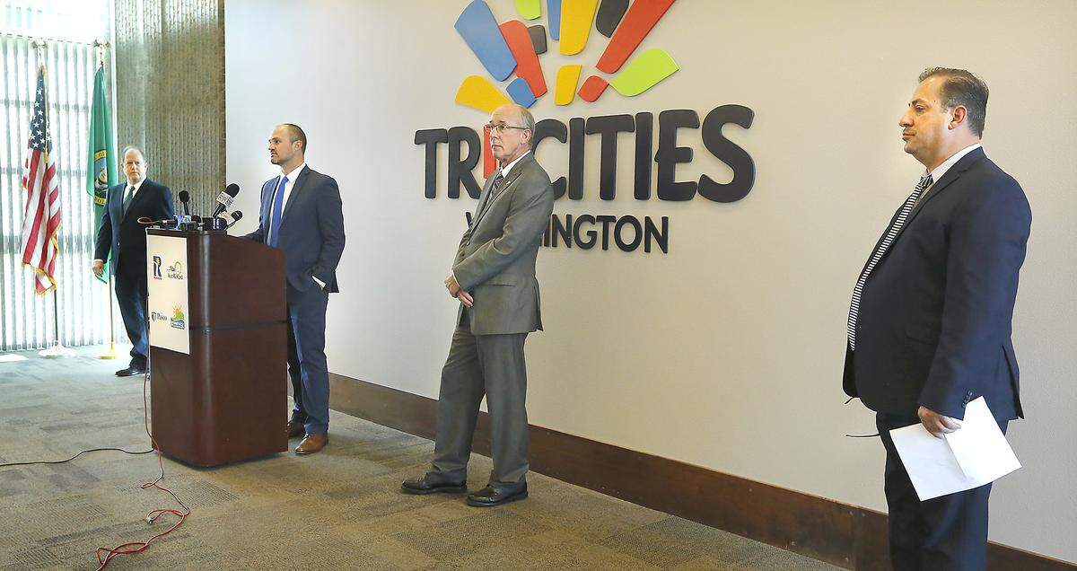 Kennewick Mayor Don Britain, Richland Mayor Ryan Lukson, West Richland Mayor Brent Gerry and Pasco Mayor Saul Martinez, from left, maintain proper social distance during a joint news conference about how their cities are responding to the coronavirus pandemic. 