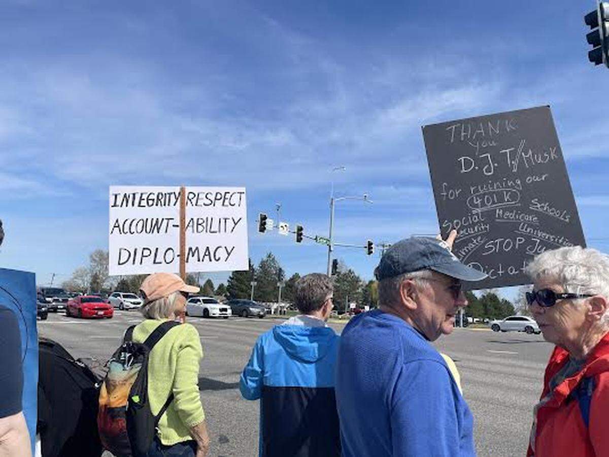 Hundreds of people lined Columbia Center Boulevard in Kennewick Saturday for a “Hands Off! Kennewick Fights Back,” to protest Trump administration policies.