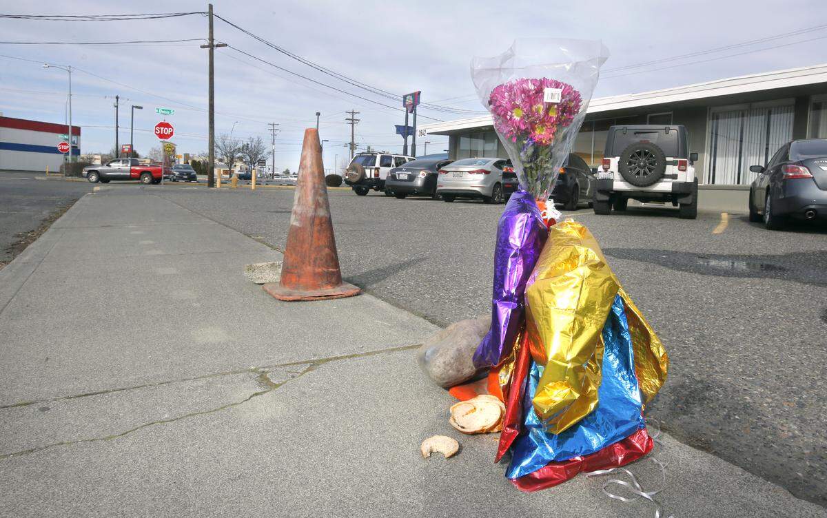 A makeshift memorial was placed on the sidewalk of West Bruneau Place in Kennewick where Patrick S. Romero, 21, was fatally shot Saturday. Police later arrested Raheem Mayberry, 19, on suspicion of rendering criminal assistance in the shooting. Details of his alleged involvement were not yet released. Watch a video at: tricityherald.com