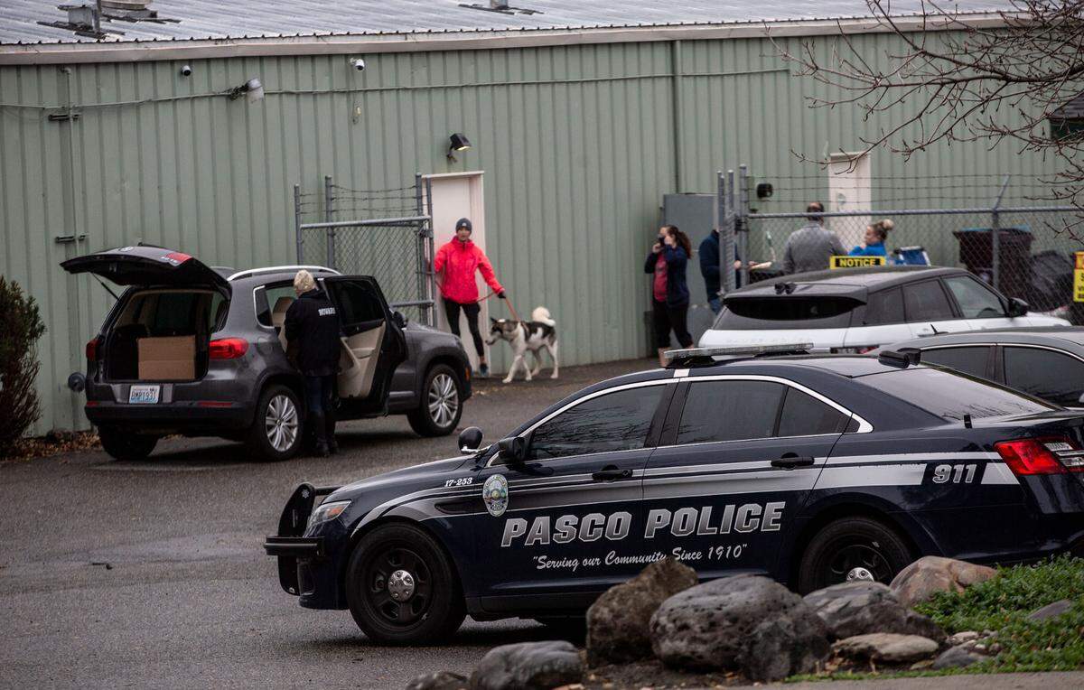 Tri-Cities Animal Shelter director Rebecca Howard, left, loads her car in November 2021 after Pasco police removed dozens of reportedly neglected or abused dogs and cats at the shelter.
