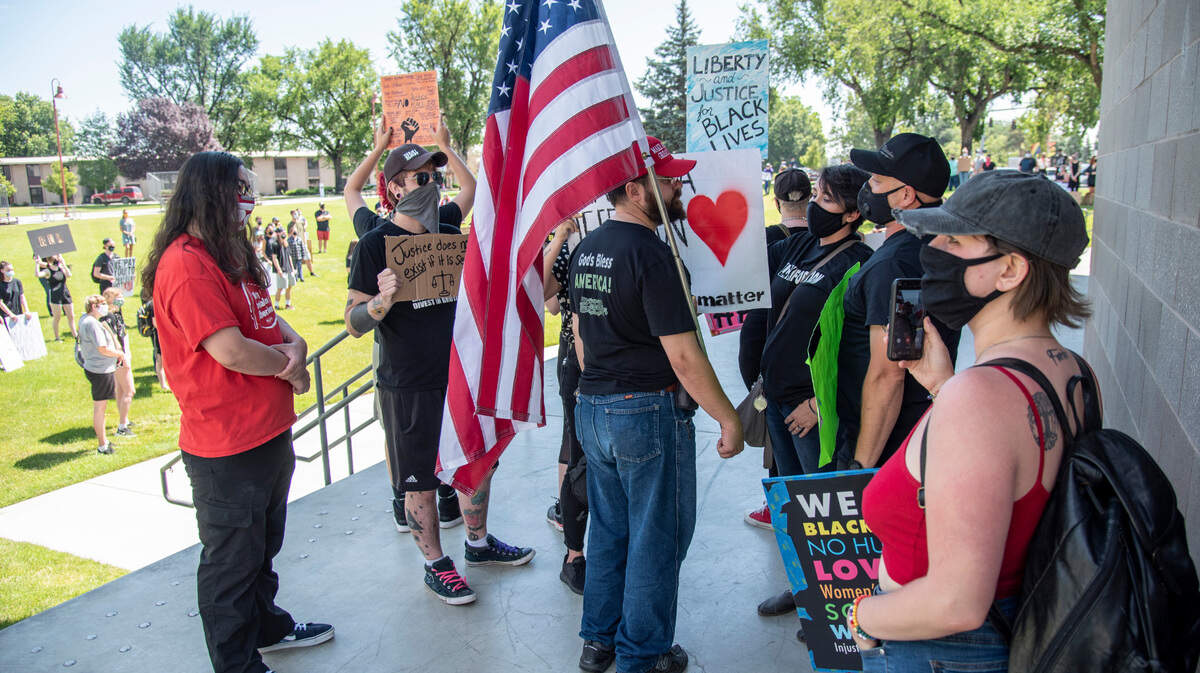 A protester attempts to distract from speakers at a Black Lives Matter demonstration Saturday organized by Blackformation in John Dam Plaza in Richland.