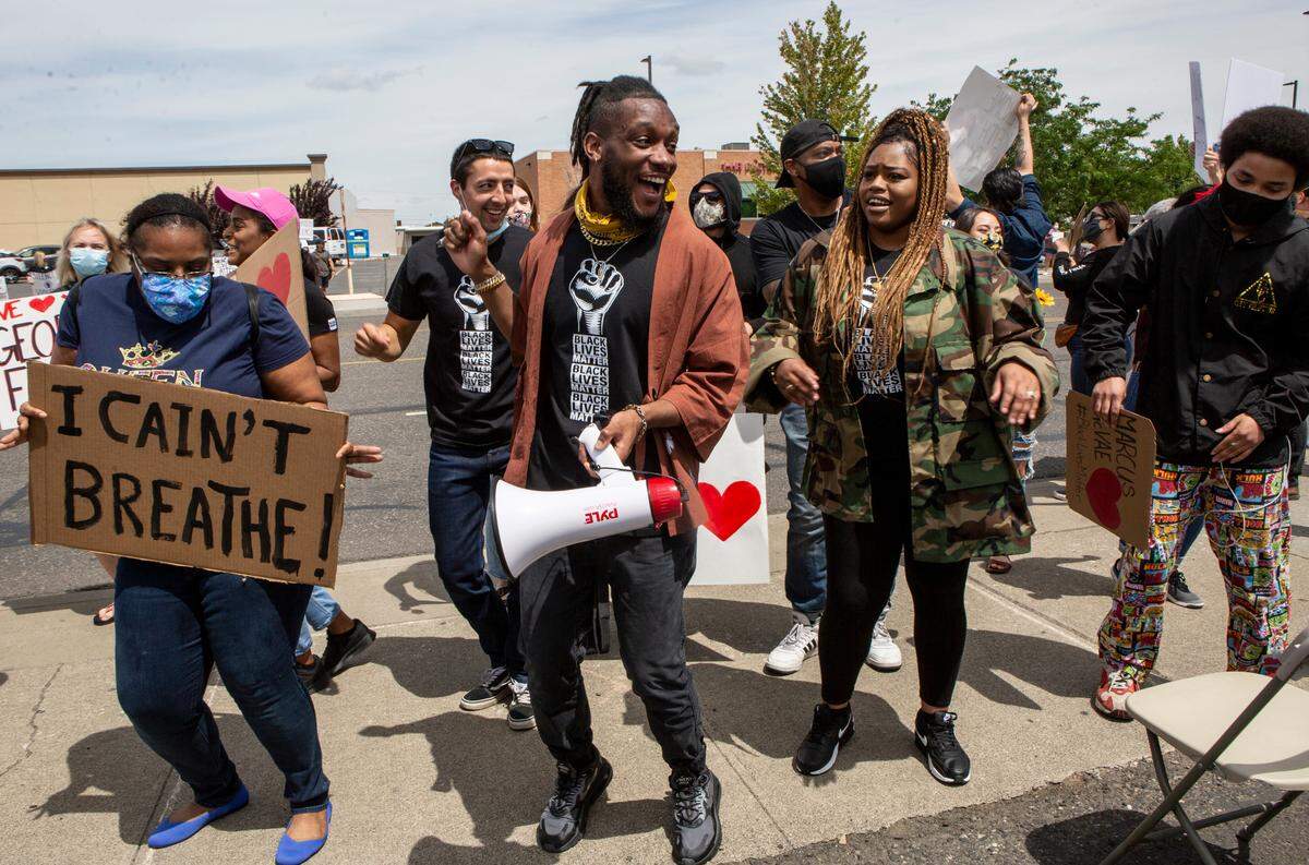 A group of demonstrators dance to the Cupid Shuffle along Court Street in Pasco on Saturday during a peaceful protest against police brutality and racially-charged violence.