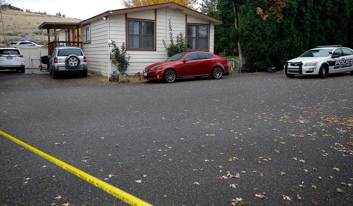 Crime scene tape and a West Richland Police Department patrol car blocks the roadway at the scene of Monday’s early morning drive-by shooting.