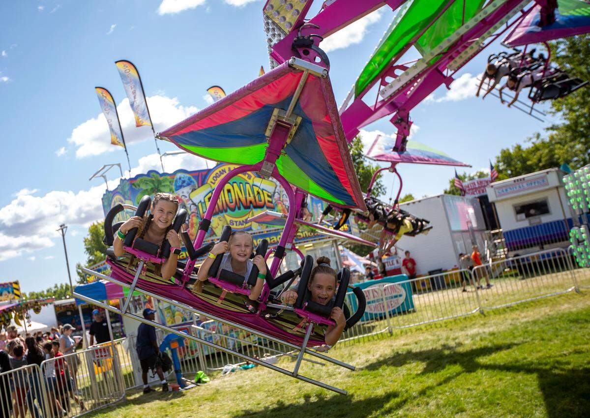 Hadley Bleazard 11, Tayla Bleazard, 7, and Macy Beus, 11, ride on the Wind Glider Thursday at the Benton Franklin Fair & Rodeo in Kennewick. The Wind Glider is one of three new rides at the fair this year.