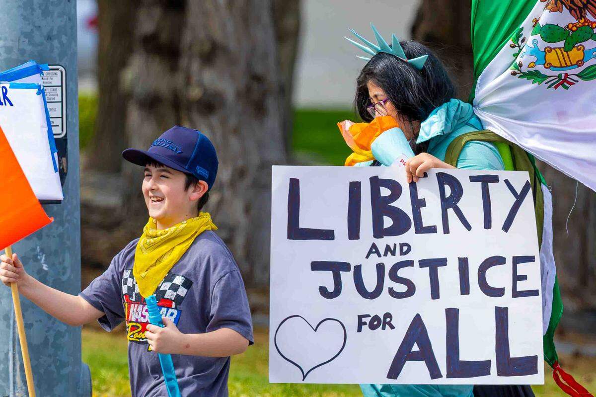 Demonstrators attend Saturday’s “No Kings” protest in Kennewick, protesting the Trump Administration and its military escalation in Iran.