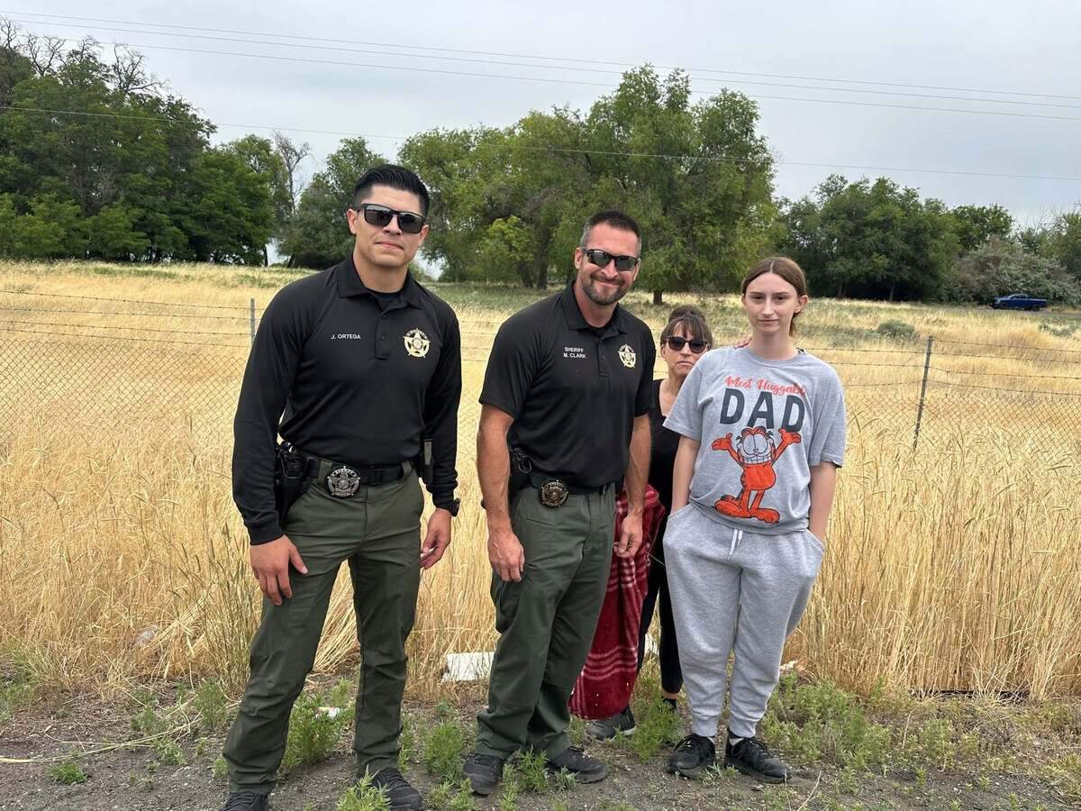 Benton County Sheriff Mike Clark led a fawn rescue team along Highway 240 in Kennewick Monday morning, joined by Deputy Jonathan Ortega and passersby Alexandria and Lisa Goforth.