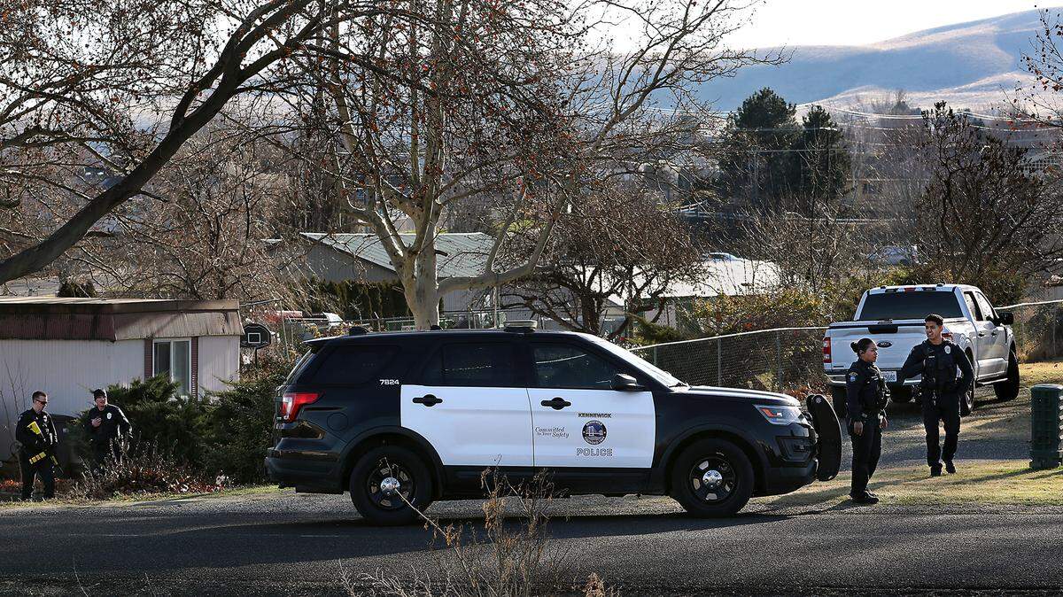 Kennewick police officers search the residential area on West 24th Avenue just west of South Ely Street Tuesday afternoon for a driver that failed to pull over for a traffic stop then ran away after crashing the car he was driving.