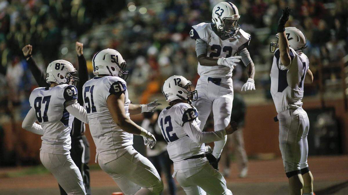 Chiawana celebrates a touchdown by Sisay West (23) last season against Richland. West returns at receiver for the Riverhawks, who open the season Aug. 31 against the Bombers.