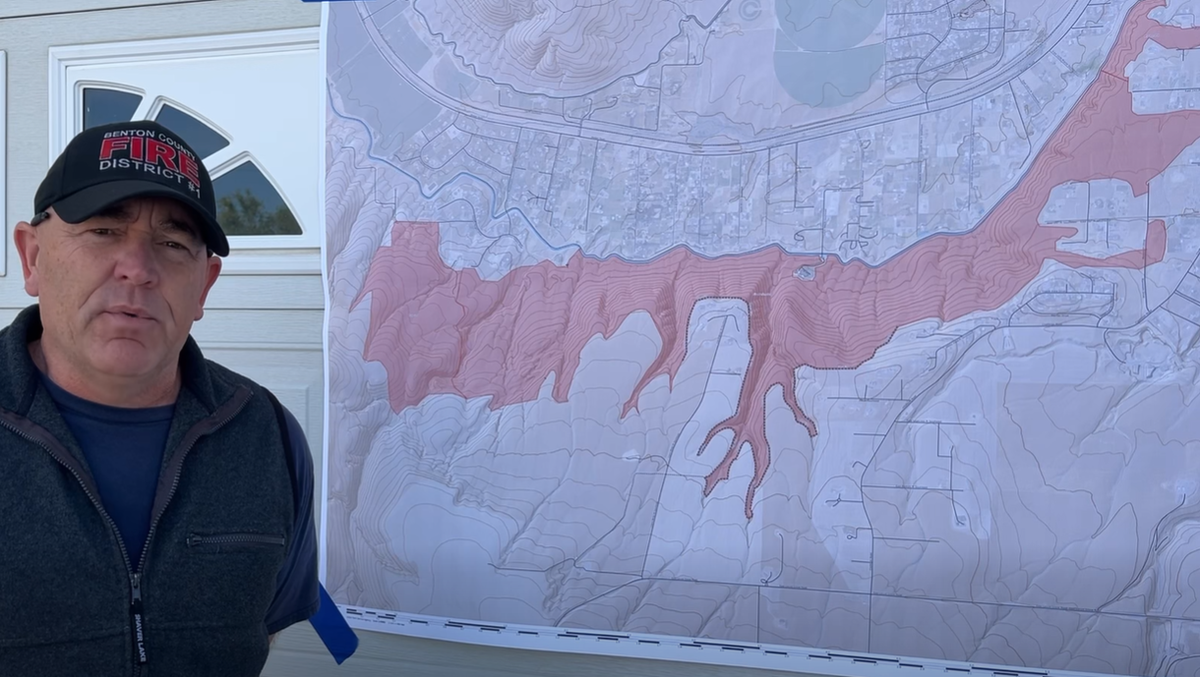 Deputy Chief Ryan Nicholls with Benton Fire District 1 shows a map of the Country Meadows Fire that started near Kennewick Saturday.