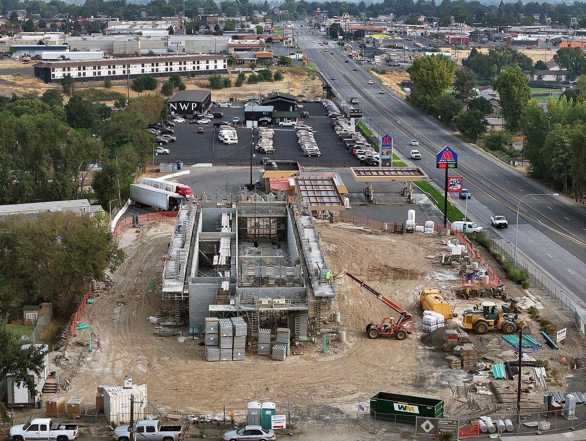 The newest Tri-Cities location for Surf Thru Express is being constructed atop a massive rock retaining wall.