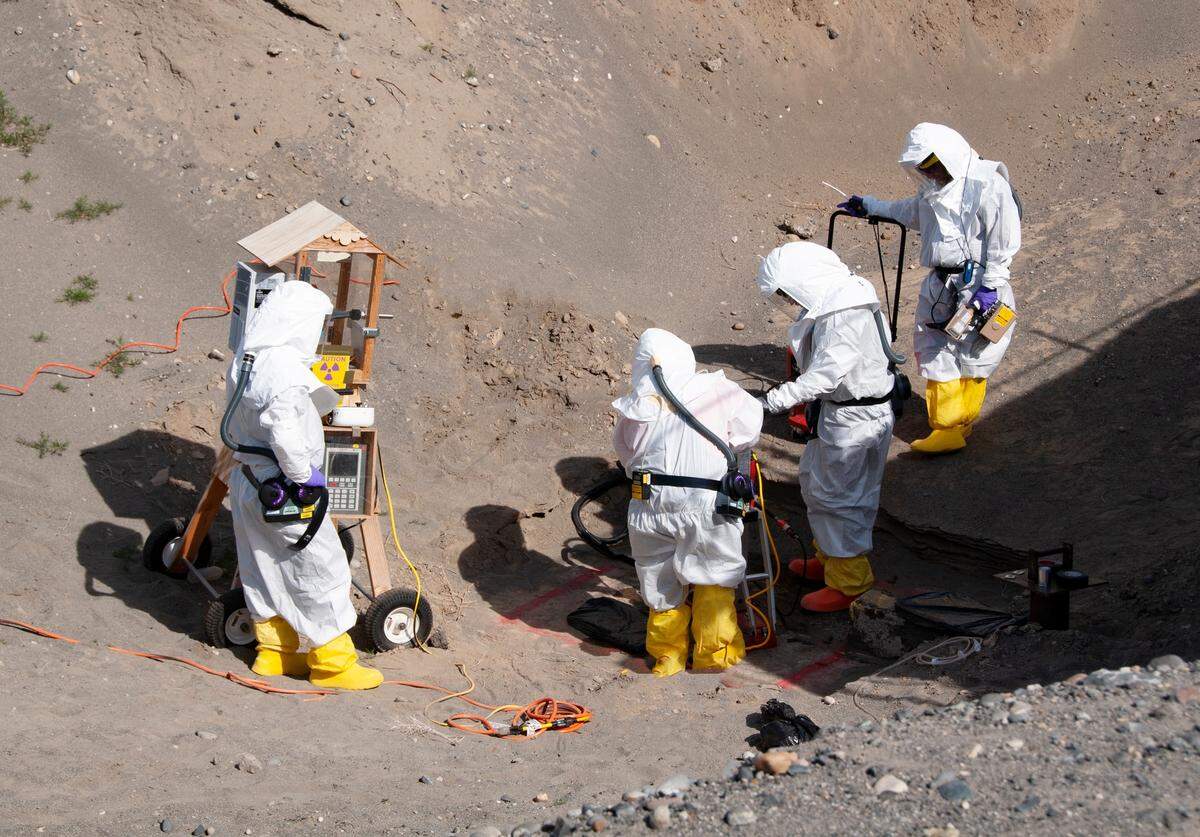 Hanford workers drill through a one-foot-thick concrete wind tunnel at the Hanford site REDOX irradiated nuclear fuel reprocessing plant to take radiological samples inside the tunnel.