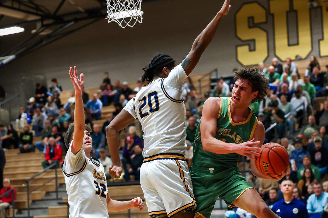 Richland’s Landen Northrop works around Southridge’s Demario Cruz during the Bombers’ 109 to 53 win Jan. 23 at Southridge High in Kennewick.