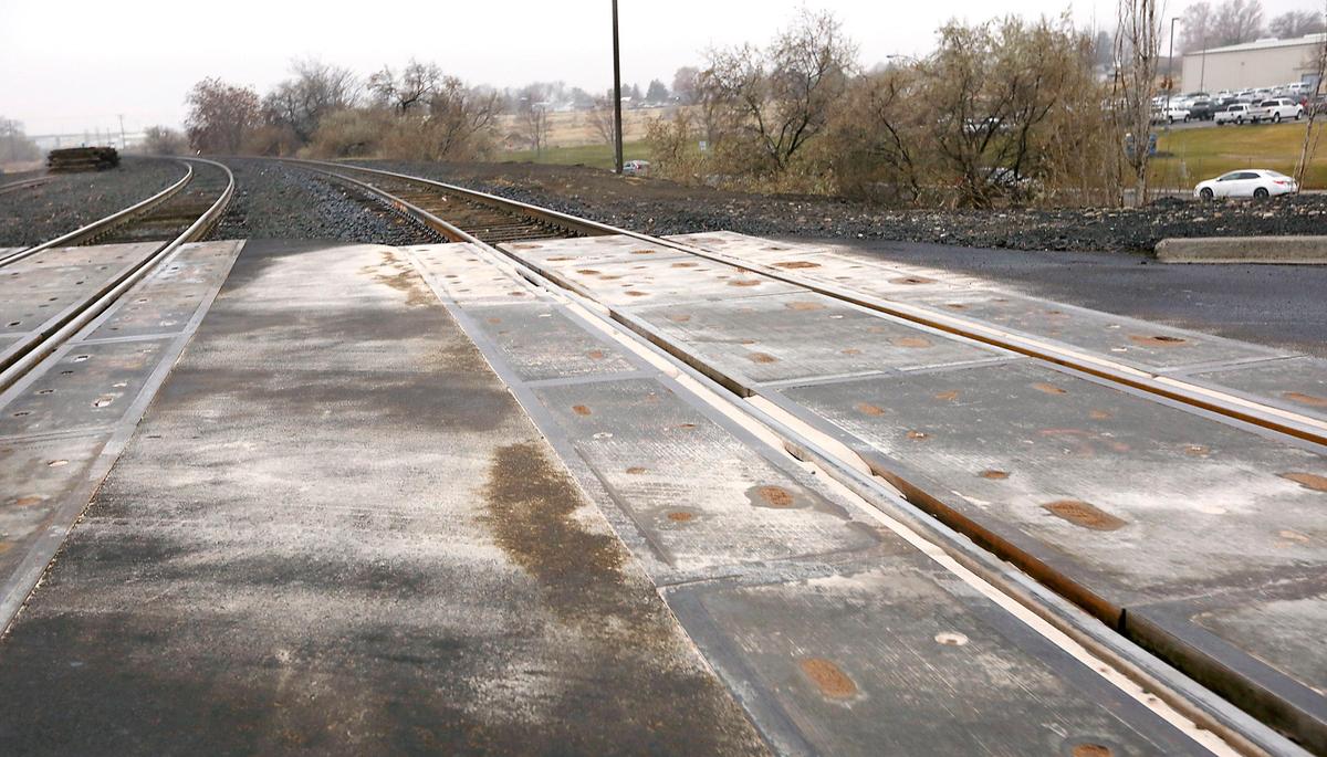 An absorbent material appears to have been spread across the railroad crossing Monday morning at East 3rd Avenue near East Chemical Drive in Kennewick after a Burlington Northern Santa Fe train spilled about 200 gallons of diesel fuel along 9 miles of track from Pasco to Finely.