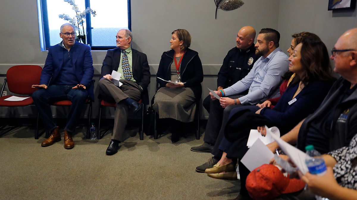 Gov. Jay Inslee, far left, conducts a roundtable discussion on dangerous drugs and mental health with community members, community leaders and professionals in the field of substance use and mental disorders Friday at MERIT Resource Services in Kennewick.