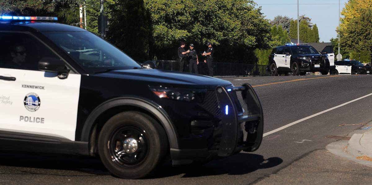 Kennewick police patrol vehicles temporarily block West 27th Avenue between South Tacoma Street and South Vancouver Street early Monday morning as officers investigate a fatal collision involving a pedestrian. 