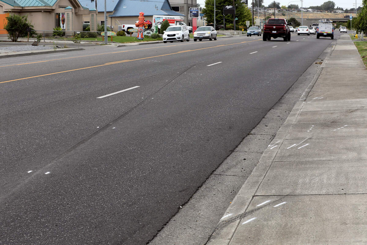 Police investigative paint marks the secene where motorcyclist Donald “Garth” Rettinghouse, 69, was struck and killed on West Columbia Drive at the North Jean Street instersection Sunday night in Kennewick while driving his motorcycle.