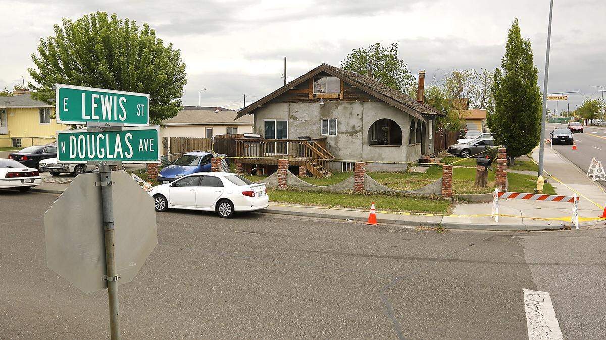 Crime scene tape and traffic barricades encircle the house at 1901 E. Lewis St. in Pasco where one man was fatally shot and two others wounded.