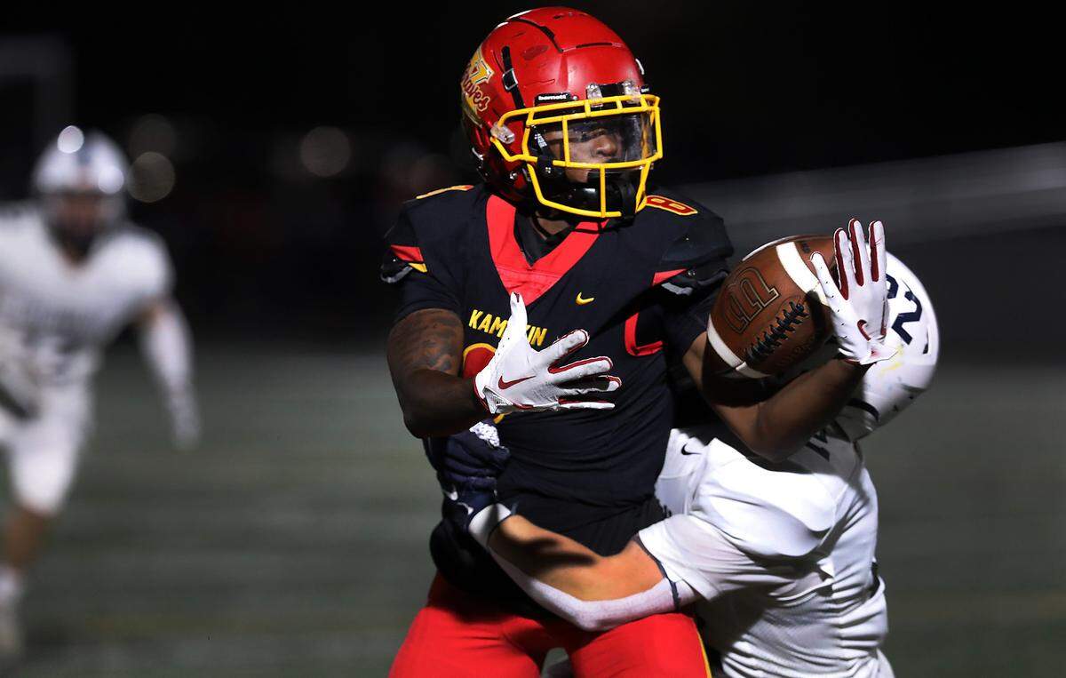 Kamiakin’s Robert Julima can’t find the handle to hold onto this pass under heavy pressure from Chiawana defender Taytan Cissne during Thursday Sept, 12, 2024 game at Lampson Stadium in Kennewick.