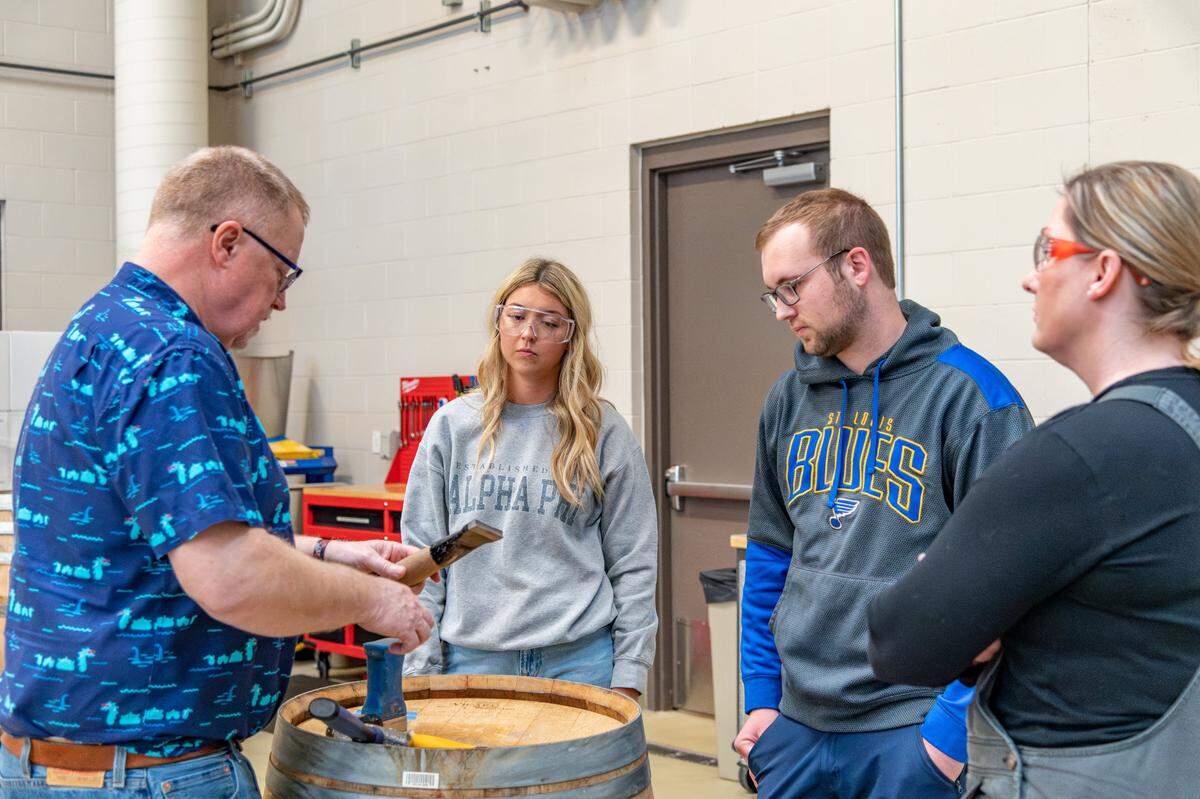 Students and staff in the Viticulture and Enology Department at WSU Tri-Cities deconstruct a wine barrel in April 2023.