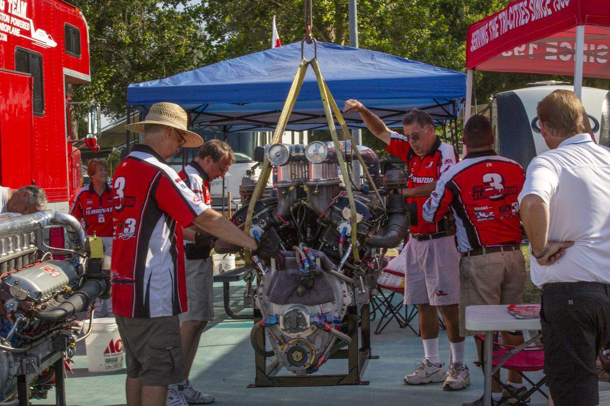 Crew members with U-3 Go3 Racing work on an engine for their piston-powered boat during Water Follies at Columbia Park in Kennewick.