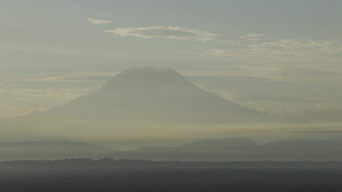Mount Rainier in Washington state is surrounded Aug. 27 in a haze of wildfire smoke. Firefighters have been battling blazes across the state for weeks.