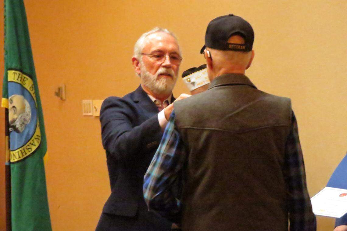 Rep. Dan Newhouse, R-Sunnyside, places a pin on a Vietnam veteran’s jacket during a pinning ceremony Saturday at the Richland Red Lion.