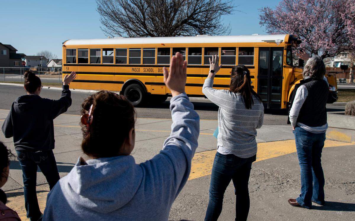 Teachers wave goodbye to their students after Tri-City shools closed for six weeks starting on March 16 in an attempt to slow the spread of the novel coronavirus.