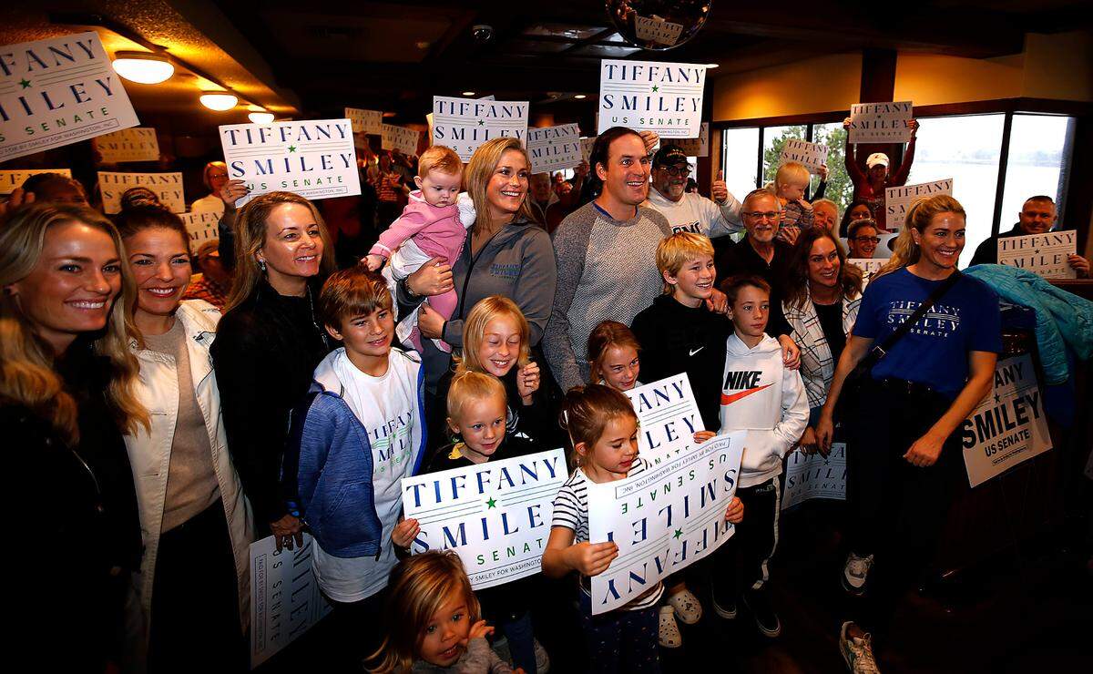 Former U.S. Senate candidate Tiffany Smiley stands next to her husband, Scotty, and family, friends and supporters in 2022 during her “New Mom in Town Tour” stop at the Clover Island Inn in Kennewick.